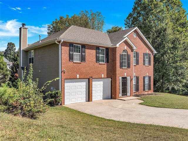 2146 Silva Ct, Conley, GA 30288 - colonial inspired home with concrete driveway, a chimney, a front lawn, brick siding, and an attached garage