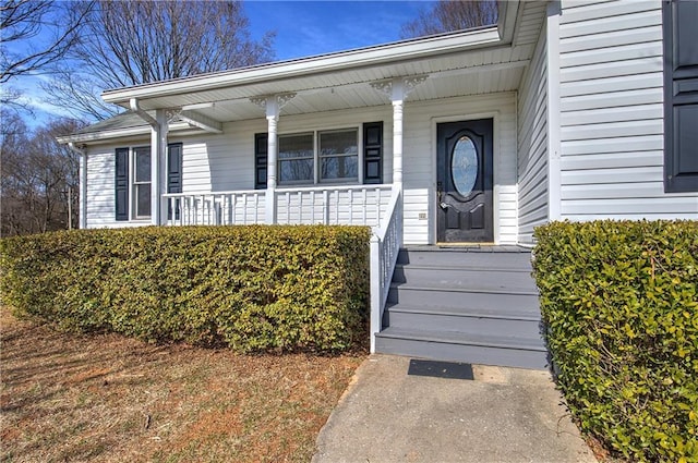 view of exterior entry with a porch