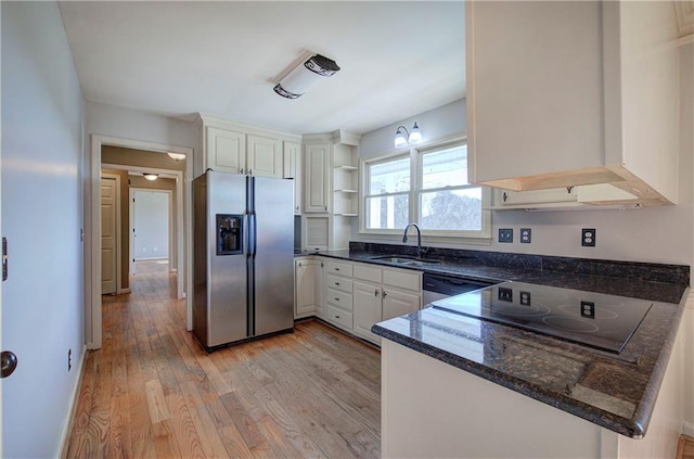 kitchen featuring light hardwood / wood-style floors, kitchen peninsula, sink, stainless steel appliances, and white cabinets