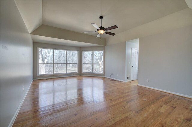 spare room featuring ceiling fan, vaulted ceiling, and light hardwood / wood-style floors