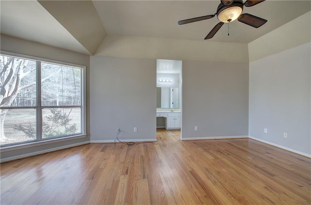 interior space with light wood-type flooring, ceiling fan, vaulted ceiling, and plenty of natural light