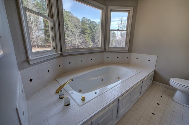 bathroom with toilet, a bathing tub, and tile patterned floors