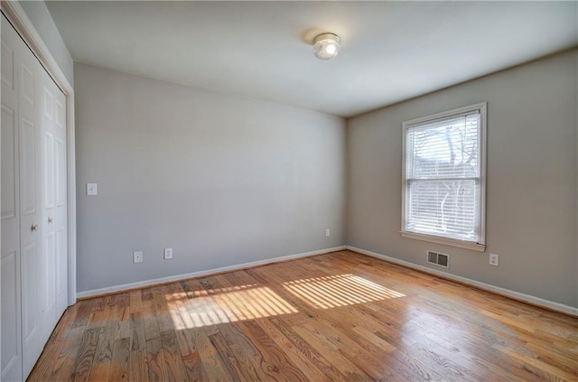 unfurnished room with light hardwood / wood-style flooring