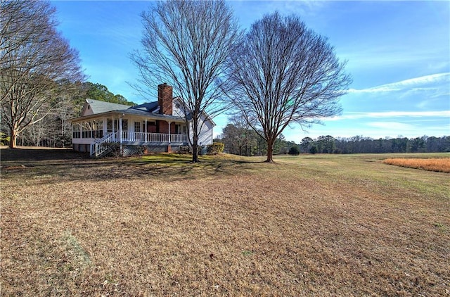 view of yard with covered porch