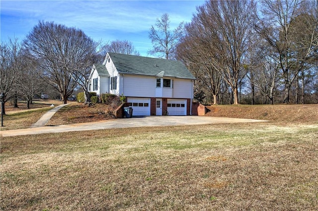 view of side of home with a lawn and a garage