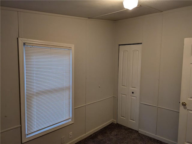 empty room featuring dark carpet