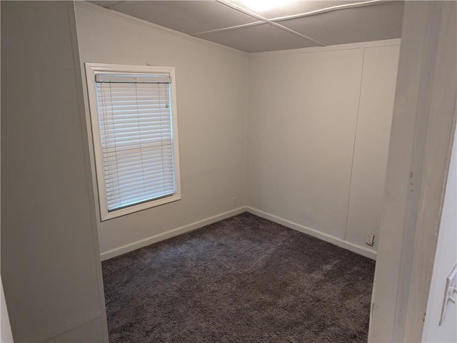 carpeted empty room featuring baseboards