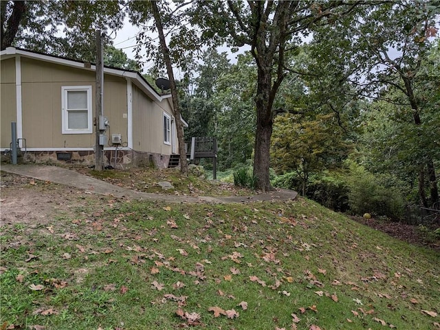 view of property exterior with a wooden deck and a yard