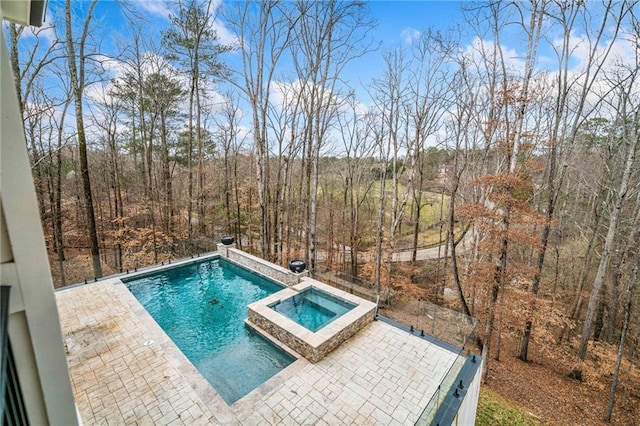 view of pool with a pool with connected hot tub and a patio area