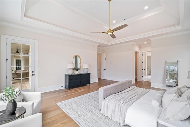 bedroom with light wood-style flooring, a raised ceiling, baseboards, ornamental molding, and recessed lighting
