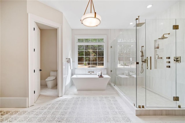 bathroom with a soaking tub, recessed lighting, a shower stall, and toilet