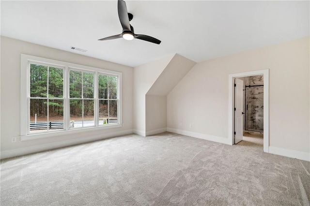additional living space with carpet, visible vents, baseboards, and ceiling fan