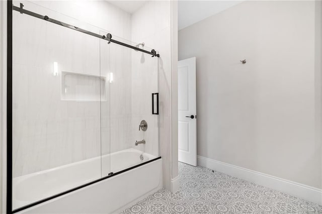 bathroom with shower / bath combination with glass door and baseboards