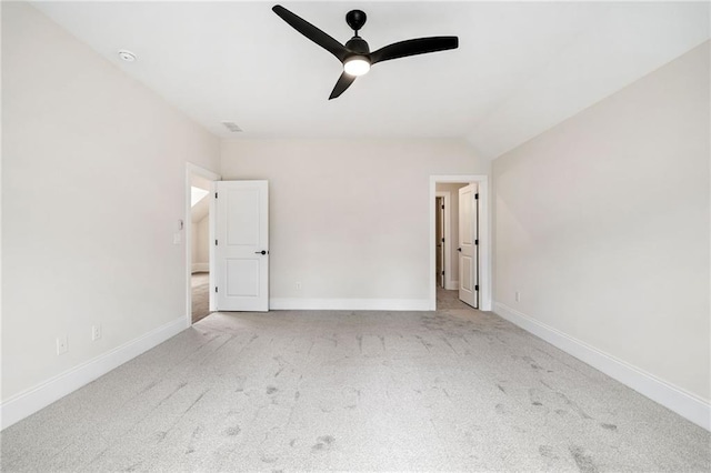 unfurnished bedroom featuring lofted ceiling, baseboards, carpet flooring, and ceiling fan