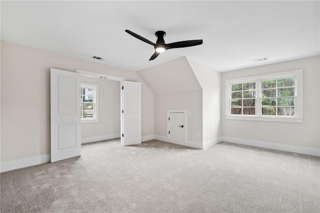 bonus room featuring carpet floors, a ceiling fan, visible vents, and baseboards