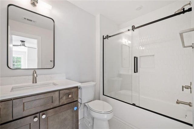 bathroom featuring shower / bath combination with glass door, tile patterned floors, visible vents, toilet, and vanity