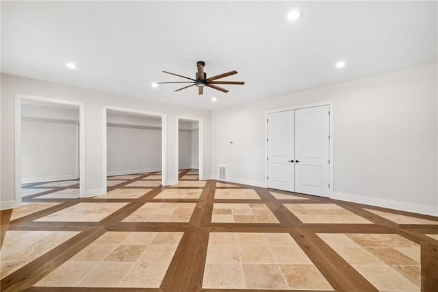 unfurnished bedroom featuring baseboards, multiple closets, visible vents, and recessed lighting