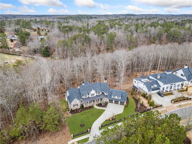 drone / aerial view featuring a forest view