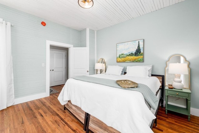 bedroom featuring baseboards and wood finished floors