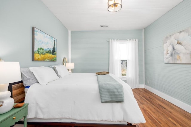 bedroom featuring baseboards and wood finished floors