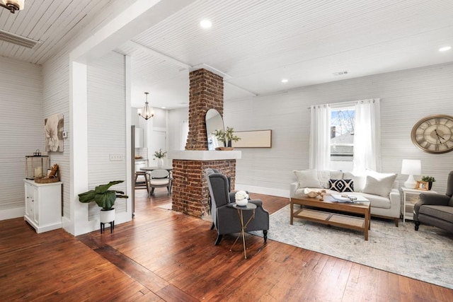 living room with a chandelier, wood-type flooring, baseboards, beam ceiling, and recessed lighting