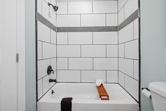 bathroom featuring toilet and  shower combination