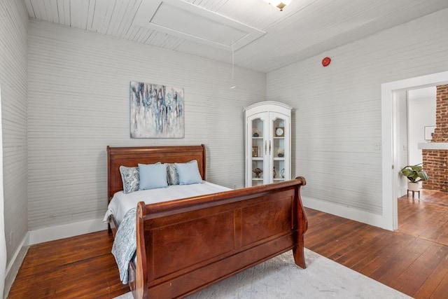 bedroom with hardwood / wood-style flooring and baseboards