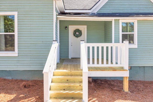 property entrance with crawl space and a shingled roof