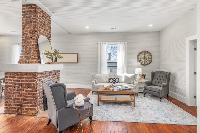 living area featuring baseboards, wood-type flooring, and recessed lighting