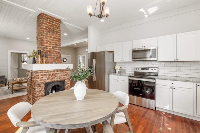 kitchen with stainless steel appliances, decorative backsplash, dark wood-style floors, white cabinetry, and recessed lighting