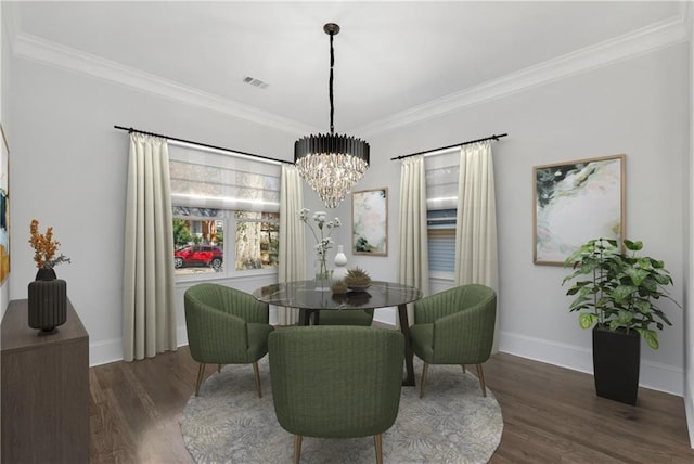 dining room with a notable chandelier, crown molding, and dark hardwood / wood-style flooring