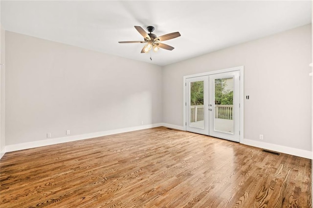 empty room featuring french doors, ceiling fan, and hardwood / wood-style floors