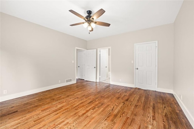 unfurnished bedroom featuring hardwood / wood-style floors and ceiling fan