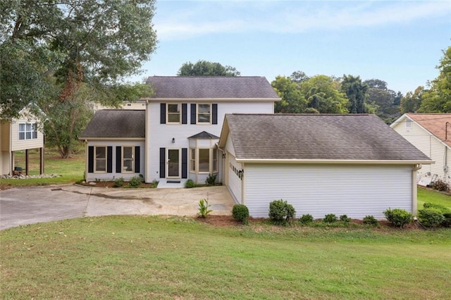 colonial house with a front yard and a garage