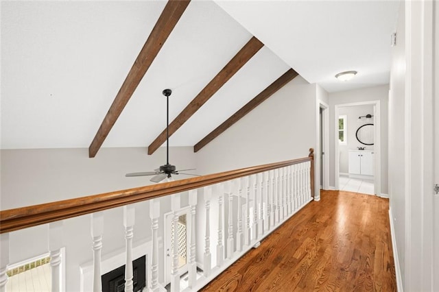 hall with vaulted ceiling with beams and hardwood / wood-style flooring