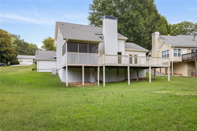 rear view of property featuring cooling unit, a yard, a sunroom, and a wooden deck