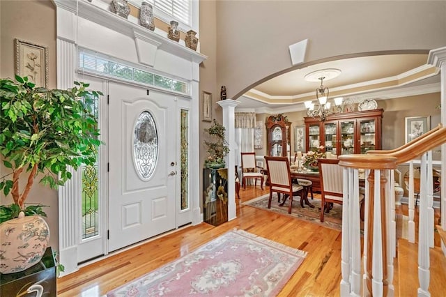 580 River Valley Dr, Dacula, GA 30019 - entryway with arched walkways, a chandelier, crown molding, ornate columns, and plenty of natural light