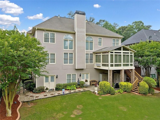 580 River Valley Dr, Dacula, GA 30019 - rear view of property with a sunroom, a patio area, a lawn, a chimney, and stairs