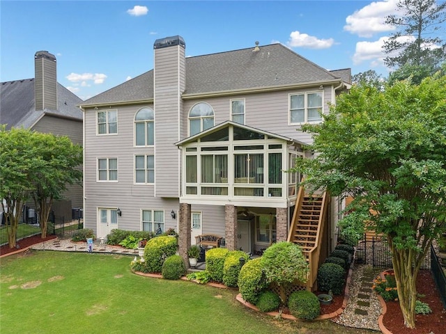 580 River Valley Dr, Dacula, GA 30019 - back of property with stairway, a sunroom, and a chimney