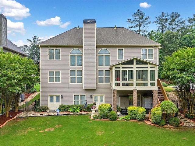 580 River Valley Dr, Dacula, GA 30019 - rear view of house with a sunroom, stairway, a chimney, and a patio area