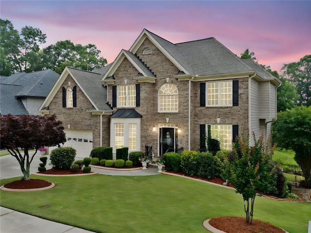580 River Valley Dr, Dacula, GA 30019 - view of front of house featuring a lawn, an attached garage, roof with shingles, and brick siding