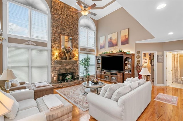 580 River Valley Dr, Dacula, GA 30019 - living area with a towering ceiling, a ceiling fan, light wood-style floors, baseboards, and a fireplace