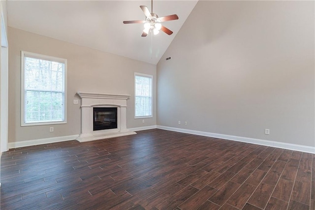 unfurnished living room featuring ceiling fan and high vaulted ceiling