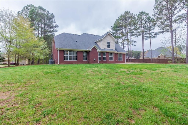 back of house featuring a lawn