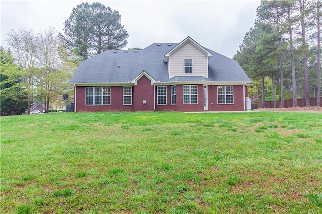 back of property featuring a lawn