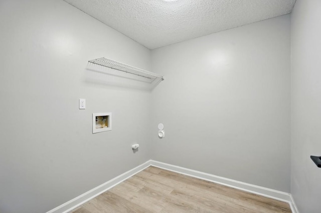 laundry room with washer hookup, laundry area, a textured ceiling, light wood-style flooring, and baseboards