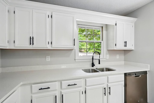 kitchen featuring a sink, light countertops, white cabinets, and stainless steel dishwasher