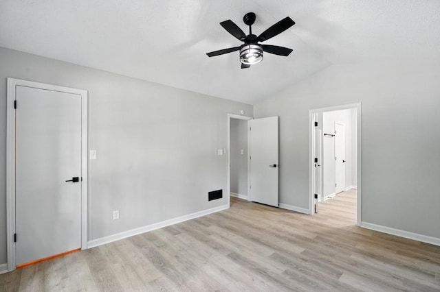 unfurnished bedroom with wood finished floors, baseboards, ceiling fan, and lofted ceiling