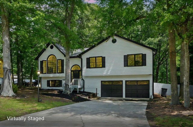 split foyer home featuring a garage and concrete driveway