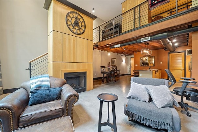 319 Atlanta St SE Unit 315, Marietta, GA 30060 - living area with a high ceiling, a fireplace, and baseboards